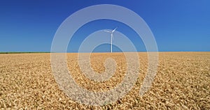 Electric Windmill against blue sky and sun. Wind Power Turbine, Renewable Energy.