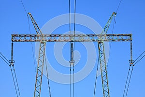 Electric wires against the blue sky. High voltage powerline tower