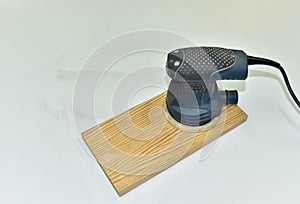 Electric Wood Sander on a wooden product. Woodworking tool concept. Furniture metal polisher, dander DIY power-tools buffer