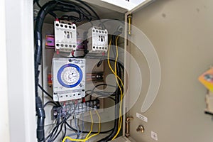 Electrical cabinet timer used to power large electrical equipment.