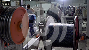 An electrical cable in isolation is wound on a metal coil