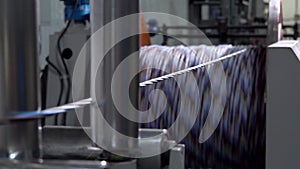 An electrical cable in isolation is wound on a metal coil