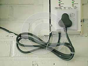 ELECTRICAL CABLE ON WHITE BRICK WALL