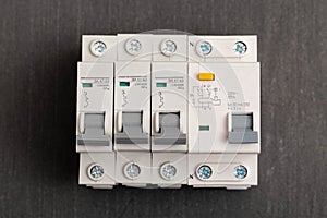 Electrical circuit breakers on a gray background, close-up. Designed for switching electrical circuits and their protection