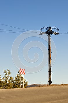 Electrical column in field under blue sky