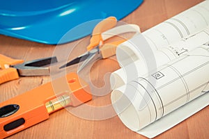 Electrical construction drawings, protective blue helmet and orange work tools for use in engineer jobs