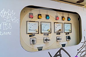 An electrical control cabinet is found on the side of the street.