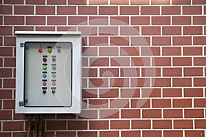 Electrical control panel on brick wall texture background