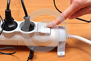 Electrical cords connected to power strip, concept of energy saving