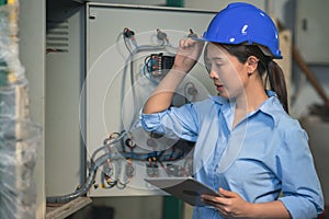 Electrical engineer checking and maintenance electric control switchboard