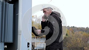 Electrical engineer checks the work done, electrical substation