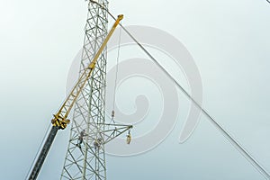Electrical engineer or electrician use the crane to lift to repair the high voltage pole