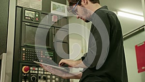 Electrical engineer hold tablet monitoring electrical system in control room. Technician inspect to control panel screen system fo