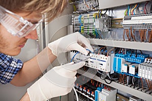 Electrical engineer repairing fusebox photo