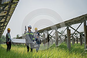 Electrical engineer on solar farm with large structure Check maintain rehearse damaged parts from use in order to produce