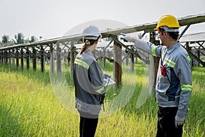 Electrical engineer on solar farm with large structure Check maintain rehearse damaged parts from use in order to produce