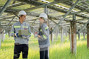 Electrical engineer on solar farm with large structure Check maintain rehearse damaged parts from use in order to produce