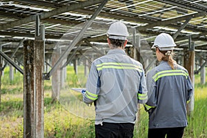 Electrical engineer on solar farm with large structure Check maintain rehearse damaged parts from use in order to produce