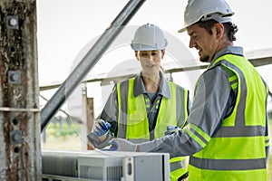 Electrical engineer on solar farm with large structure Check maintain rehearse damaged parts from use in order to produce