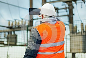 Electrical Engineer with tablet PC in the electric substation