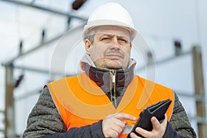 Electrical Engineer with tablet PC in the electric substation