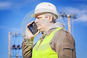 Electrical engineer talking on cell phone at outdoors