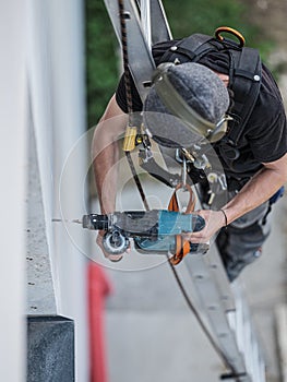 an electrical engineer of the team installs the electrical cables for the autonomous photovoltaic solar panel system. It is