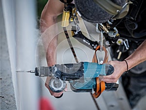 an electrical engineer of the team installs the electrical cables for the autonomous photovoltaic solar panel system. It is