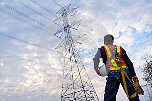 An electrical engineer or technician wear fall arrestor device for worker with hooks for safety body harness. Working at height