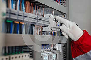 Electrical engineer turning on the fuse box