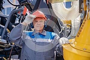 Electrical engineer worker maintains mining equipment for lowering into mine, hydraulic systems