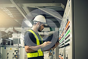 Electrical Engineer working front control panel.