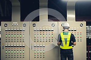 Electrical Engineer working front control panel
