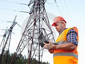 Electrical engineer working. Talking on the phone and working working on a laptop