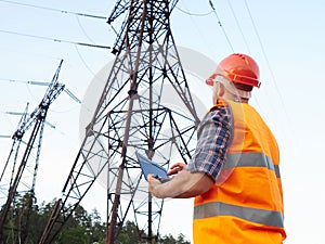 Electrical engineer working. Talking on the phone and working working on a laptop photo