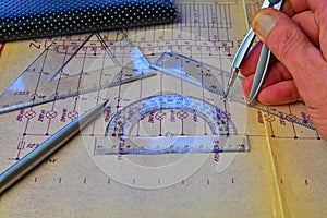Electrical engineer workplace - electrotechnical project, rulers, and divider compass. Construction and