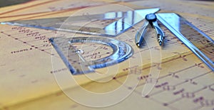 Electrical engineer workplace - electrotechnical project, rulers, and divider compass. Construction concept. Engineering