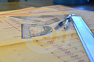 Electrical engineer workplace - electrotechnical project, rulers, and divider compass. Construction and