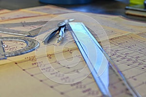 Electrical engineer workplace - electrotechnical project, rulers, and divider compass. Construction and
