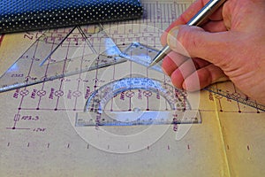 Electrical engineer workplace - electrotechnical project, rulers, and divider compass. Construction and