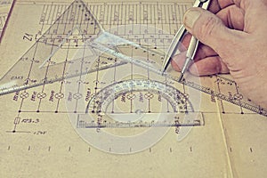 Electrical engineer workplace - electrotechnical project, rulers, and divider compass. Construction and