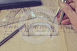Electrical engineer workplace - electrotechnical project, rulers, and divider compass. Construction and