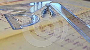 Electrical engineer workplace - electrotechnical project, rulers, and divider compass. Construction and