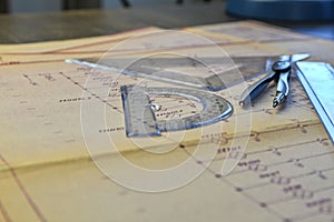 Electrical engineer workplace - electrotechnical project, rulers, and divider compass. Construction and