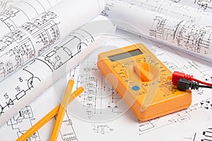 Electrical engineering drawings, pencil and digital multimeter