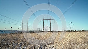 Electrical equipment, high voltage power line insulators on winter sky backdrop. Transmission tower. Intricate