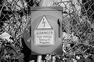 An electrical fuse box with a danger warning