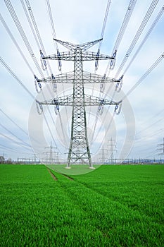 Electrical grid. A lot of high-voltage power line, transmission tower overhead line masts, high voltage pylons as power pylons