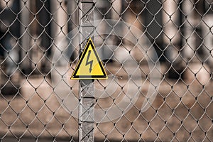 Electrical hazard sign placed on a fence of an electrical substation