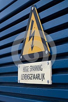 Electrical hazard sign on a triangular yellow sign